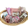 Baby gift basket with pink and white items on a white background
