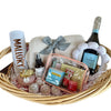Gift basket with a bottle of wine, blanket, and various items on a white background