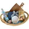 Gift basket with a bottle, soap, and Lindt chocolate on a white background