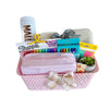 Gift basket with stationery items including a pink pencil case, markers, and a small plant on a white background.