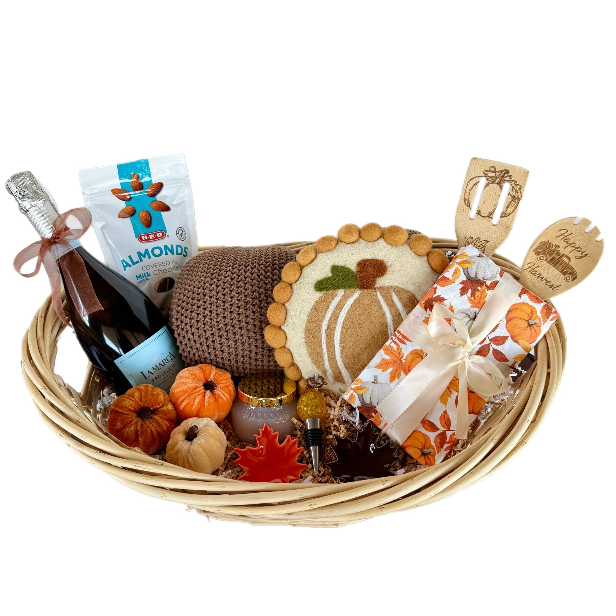Gift basket with wine, snacks, and decorative items on a white background