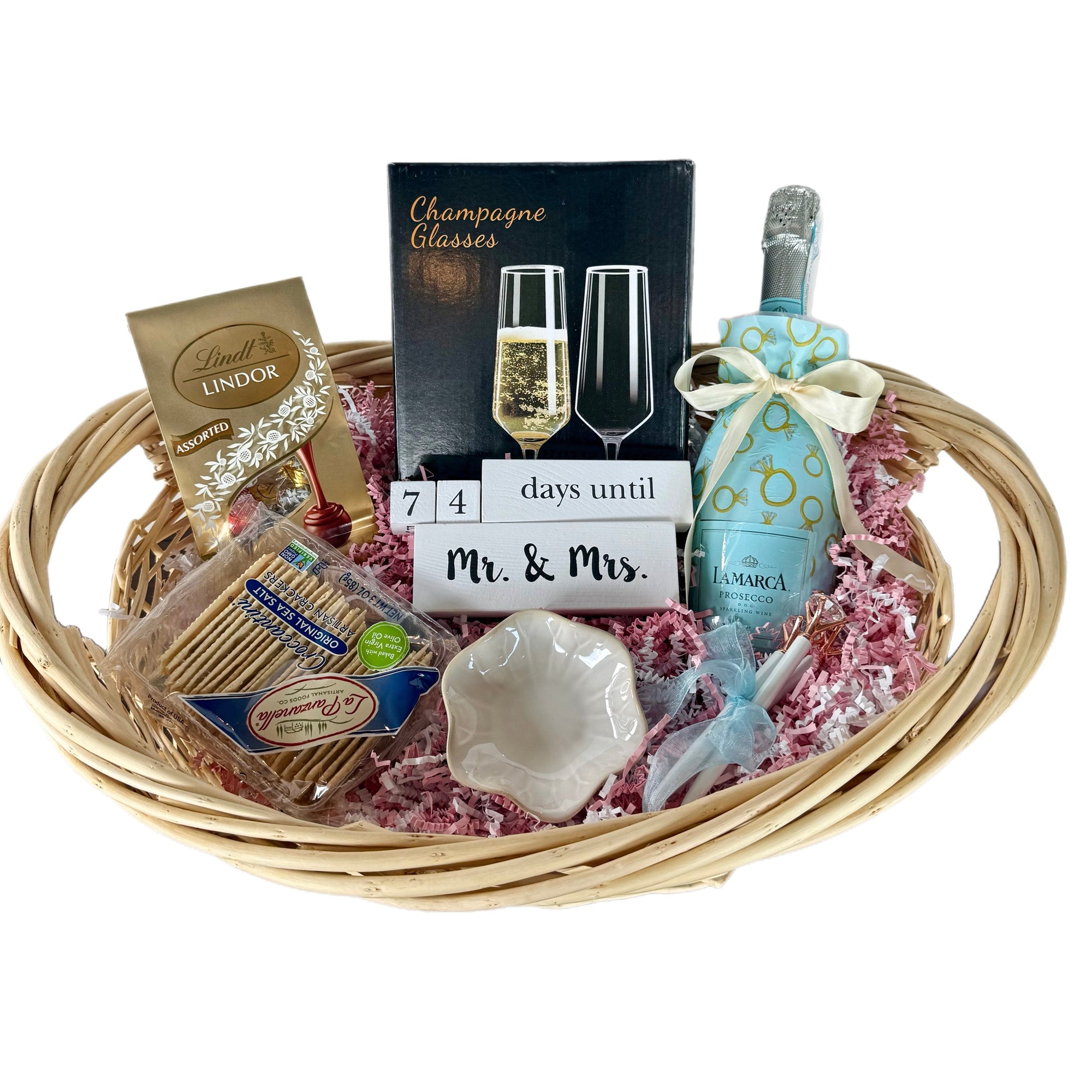 Gift basket with champagne, snacks, and a countdown card on a white background