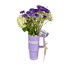 Purple flower arrangement in a mug with 'Maribel' branding on a white background